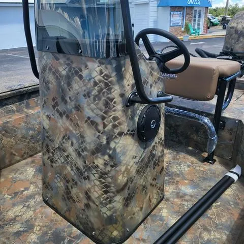 Slide: The Image of 2025 Excel 1860SWV4 Shallow Water F4 Console, camo design, steering wheel, and seating. - 10