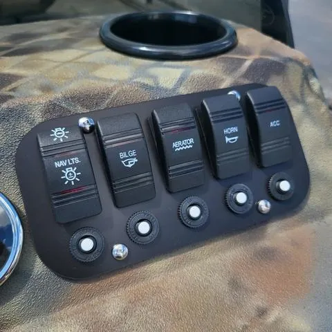 Slide: The Image of Control panel of 2025 Excel 1860SWV4 boat with switches for navigation, bilge, aerator, horn, and accessories. - 15