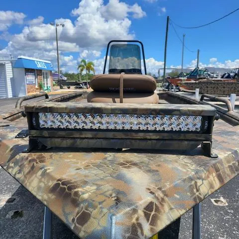 Slide: The Image of 2025 Excel 1860SWV4 Shallow Water F4 boat with camo design and LED light bar. - 3