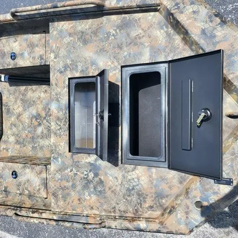 Slide: The Image of 2025 Excel 1860SWV4 Shallow Water F4 Console Series with open storage compartments. - 5