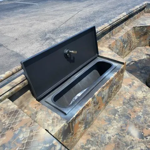 Slide: The Image of 2025 Excel 1860SWV4 Shallow Water F4 Console Series boat with open storage compartment. - 8