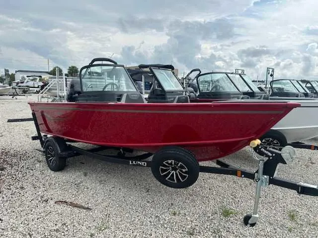 Slide: The Image of 2025 Lund 1675 Adventure Sport boat in vibrant red on a trailer. - 1