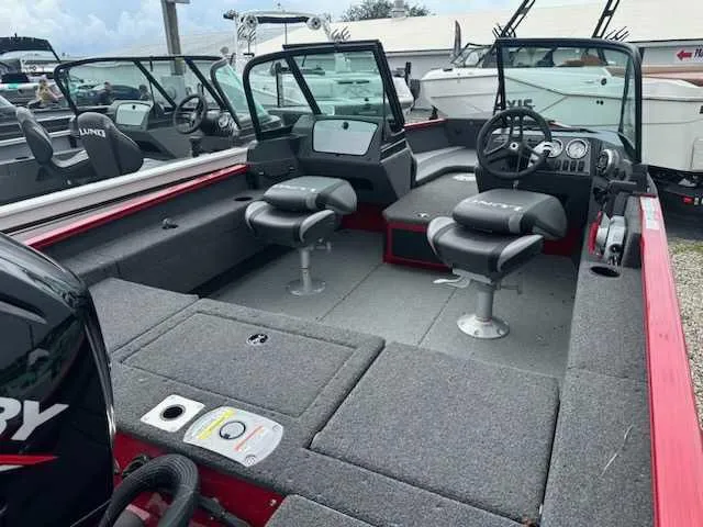 Slide: The Image of 2025 Lund 1675 Adventure Sport boat interior with seating and steering console. - 7