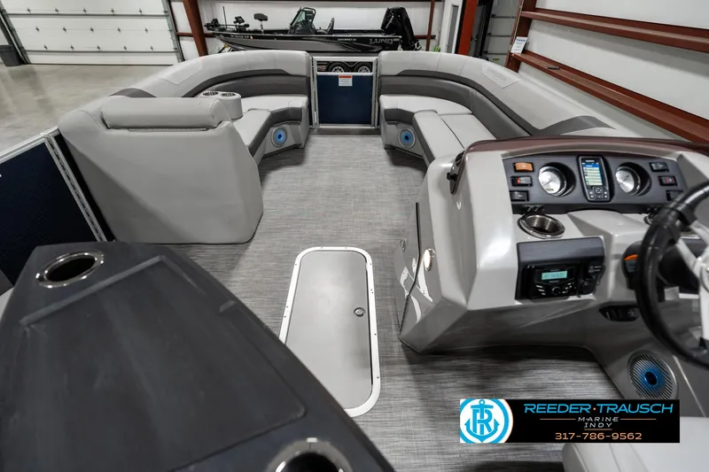 Slide: The Image of 2021 Bennington 22SX pontoon boat interior with gray seating and modern dashboard. - 17
