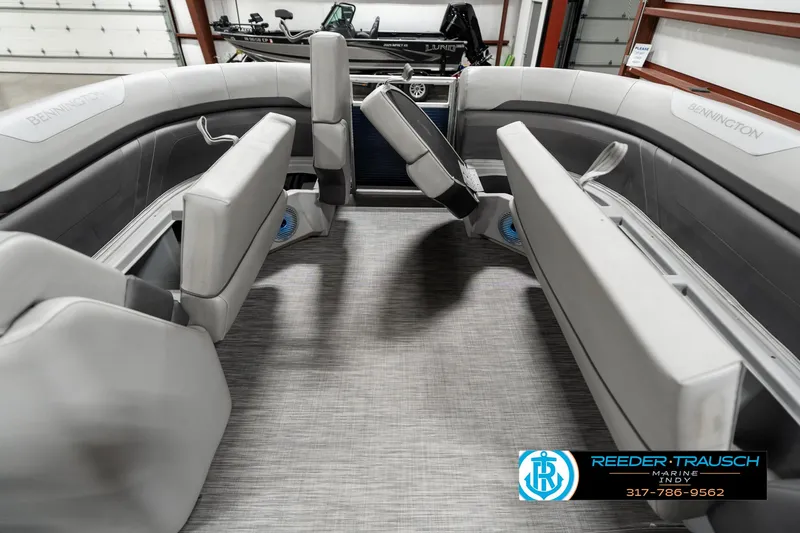 Slide: The Image of 2021 Bennington 22SX boat interior with gray seating and carpeted flooring. - 19