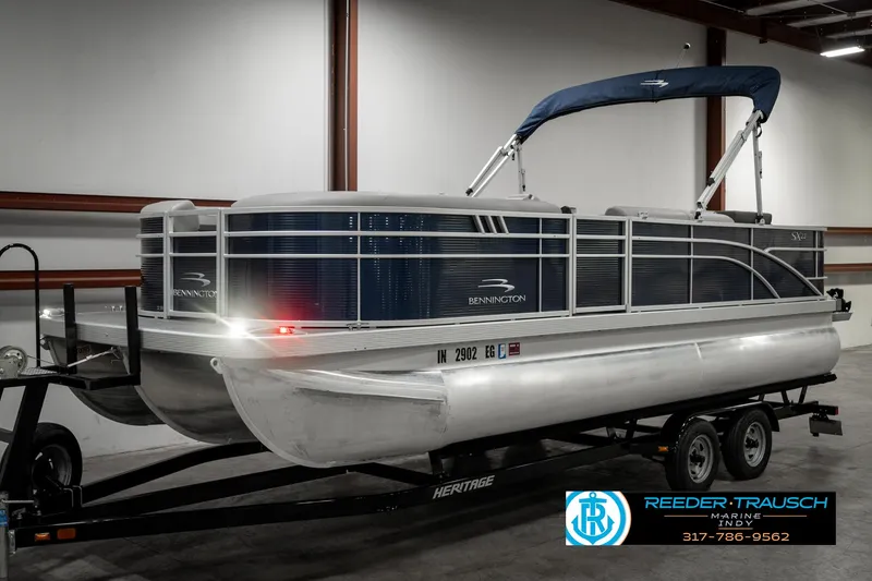 Slide: The Image of 2021 Bennington 22SX pontoon boat on trailer in indoor storage facility. - 2