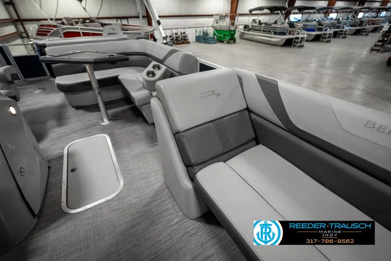 Slide: The Image of 2021 Bennington 22SX pontoon boat interior with gray seating in showroom. - 20