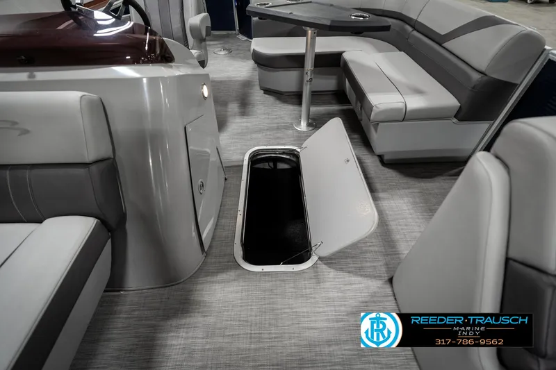 Slide: The Image of 2021 Bennington 22SX boat interior with open storage compartment and seating area. - 23