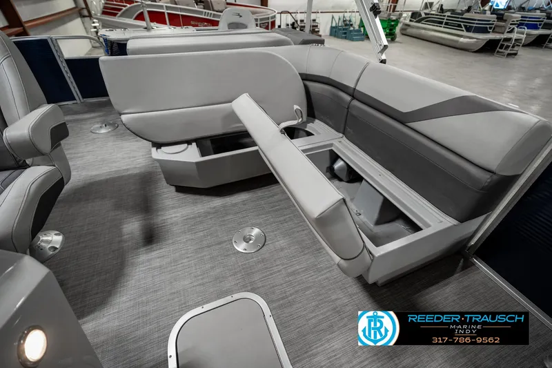 Slide: The Image of 2021 Bennington 22SX boat interior with gray seating and storage compartments. - 26