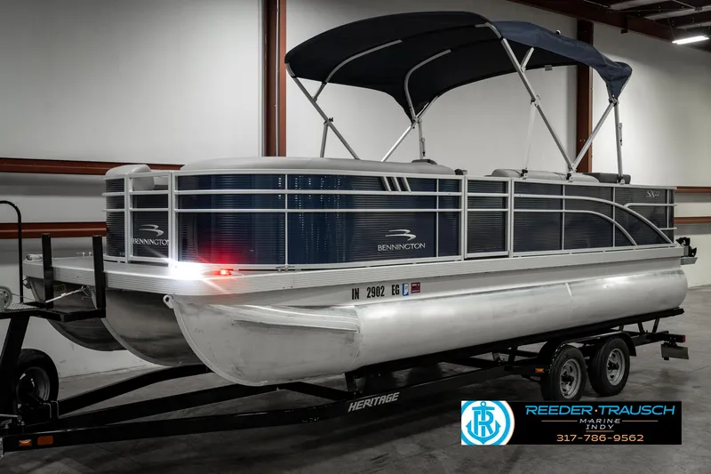Slide: The Image of 2021 Bennington 22SX pontoon boat on trailer in indoor storage. - 3