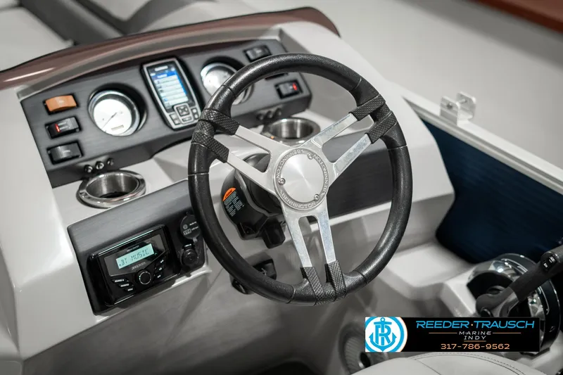 Slide: The Image of 2021 Bennington 22SX boat dashboard with steering wheel and control panel. - 34