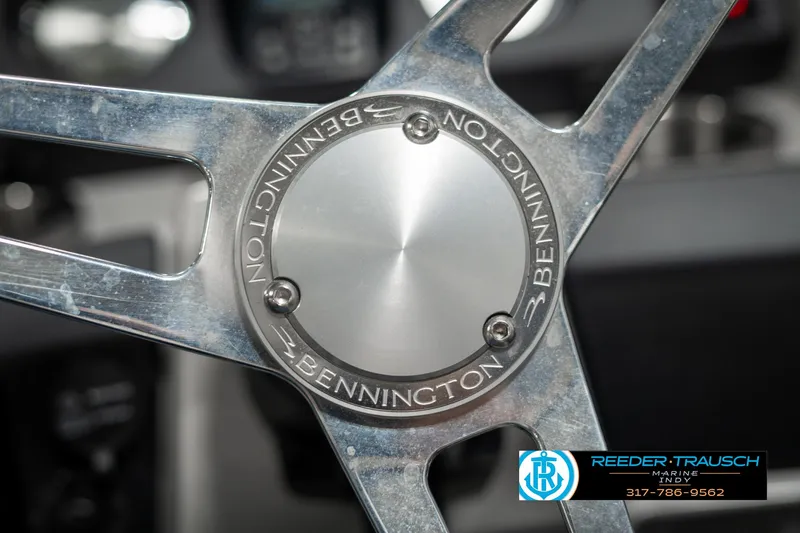 Slide: The Image of Close-up of 2021 Bennington 22SX steering wheel with logo and metallic finish. - 35