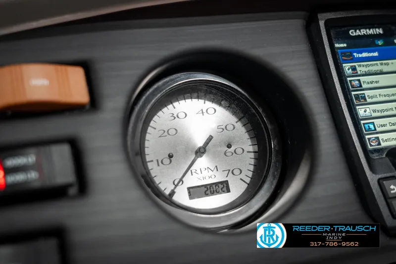 Slide: The Image of Close-up of 2021 Bennington 22SX dashboard with RPM gauge and Garmin display. - 37