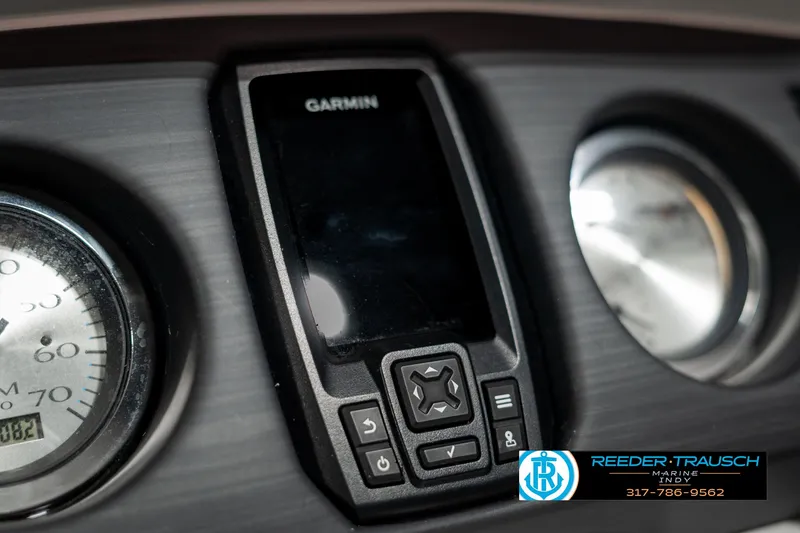 Slide: The Image of Garmin device on 2021 Bennington 22SX dashboard with gauges, Reeder-Trausch logo visible. - 38