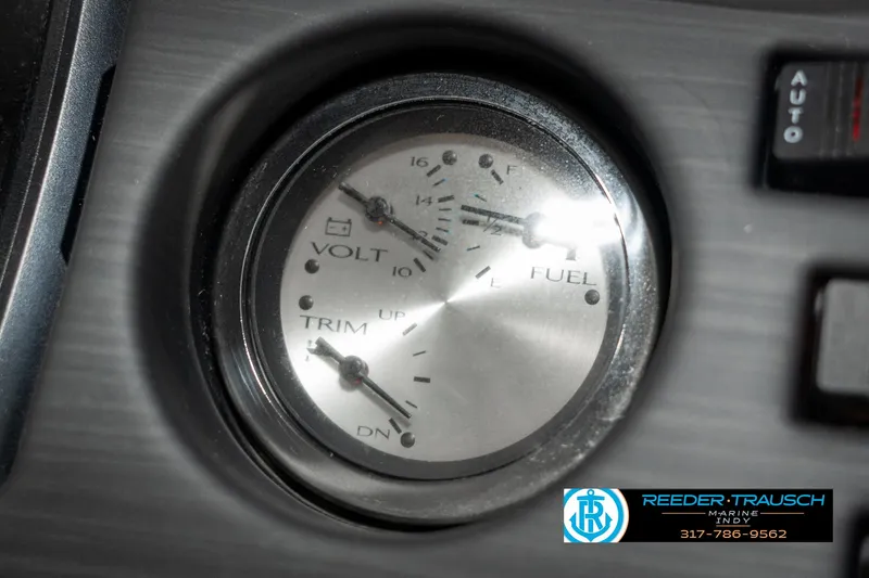 Slide: The Image of Close-up of 2021 Bennington 22SX dashboard gauges showing volt, fuel, and trim levels. - 39