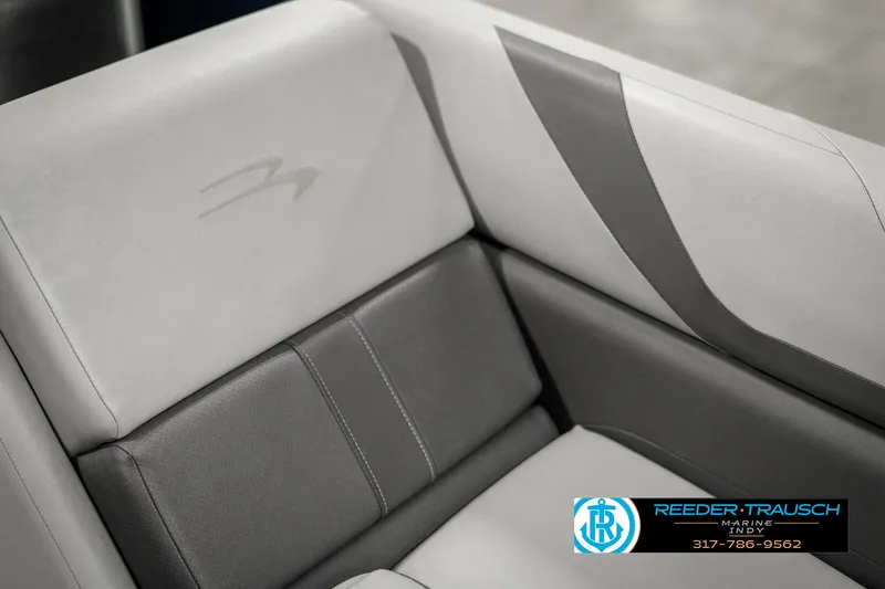 Slide: The Image of 2021 Bennington 22SX boat seat with gray and white upholstery, featuring Reeder-Trausch Marine logo. - 45