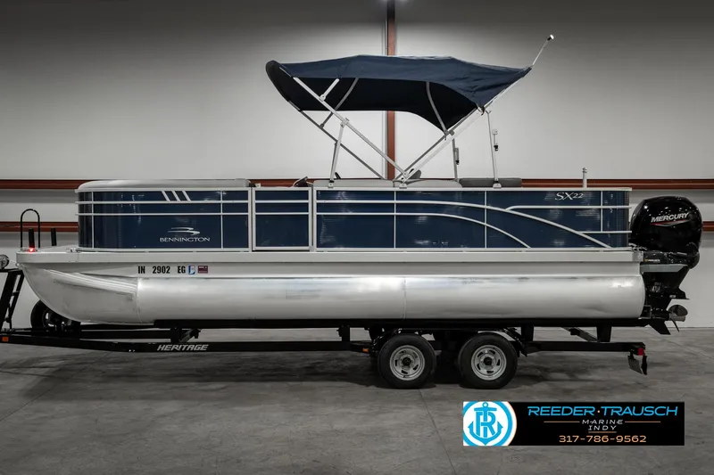 Slide: The Image of 2021 Bennington 22SX pontoon boat on trailer in indoor storage. - 5