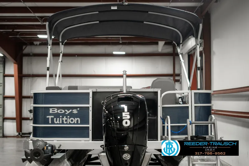Slide: The Image of 2021 Bennington 22SX pontoon boat with 150 HP engine in indoor storage. - 7