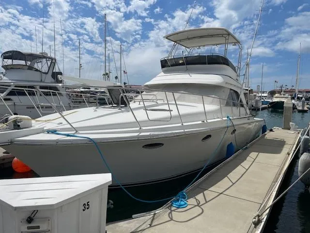 Slide: The Image of 1990 Trojan 40 Sport Fisherman 3208 Cat Diesel yacht docked at marina. - 11