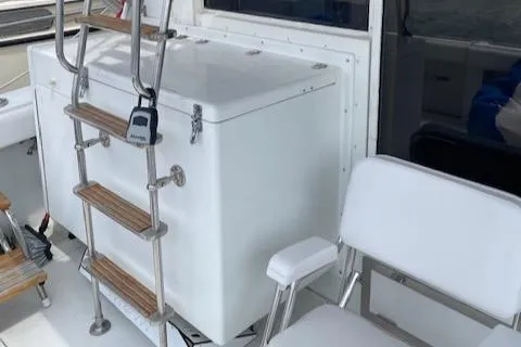 Slide: The Image of 1990 Trojan 40 Sport Fisherman boat interior with ladder and seating. - 13