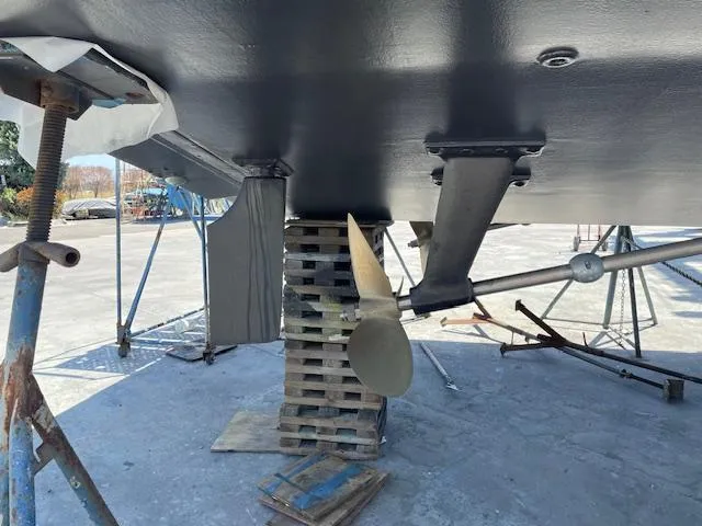 Slide: The Image of 1990 Trojan 40 Sport Fisherman boat under maintenance, showing propeller and hull support. - 19