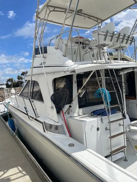 Slide: The Image of 1990 Trojan 40 Sport Fisherman boat docked, featuring a 3208 Cat Diesel engine. - 4