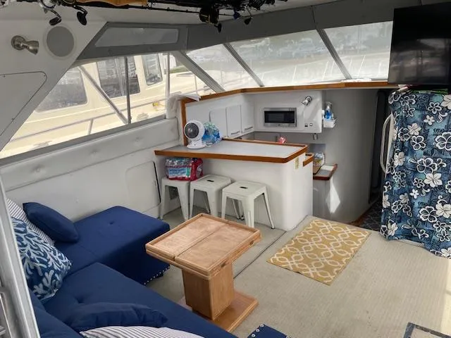 Slide: The Image of Interior of 1990 Trojan 40 Sport Fisherman with seating, kitchenette, and nautical decor. - 6