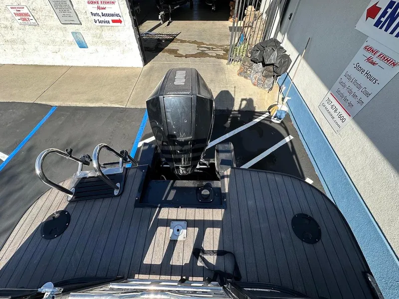 Slide: The Image of Ranger 2300LS boat, 2020 model, with outboard motor in a parking lot. - 24