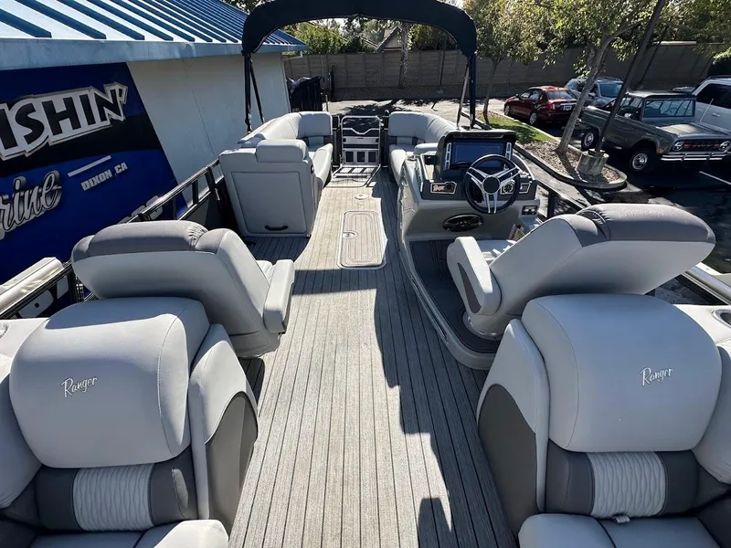 Slide: The Image of 2020 Ranger 2300LS pontoon boat with spacious seating and modern dashboard. - 26