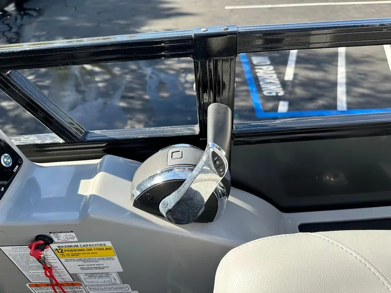 Slide: The Image of 2020 Ranger 2300LS boat throttle control in a parking lot setting. - 33