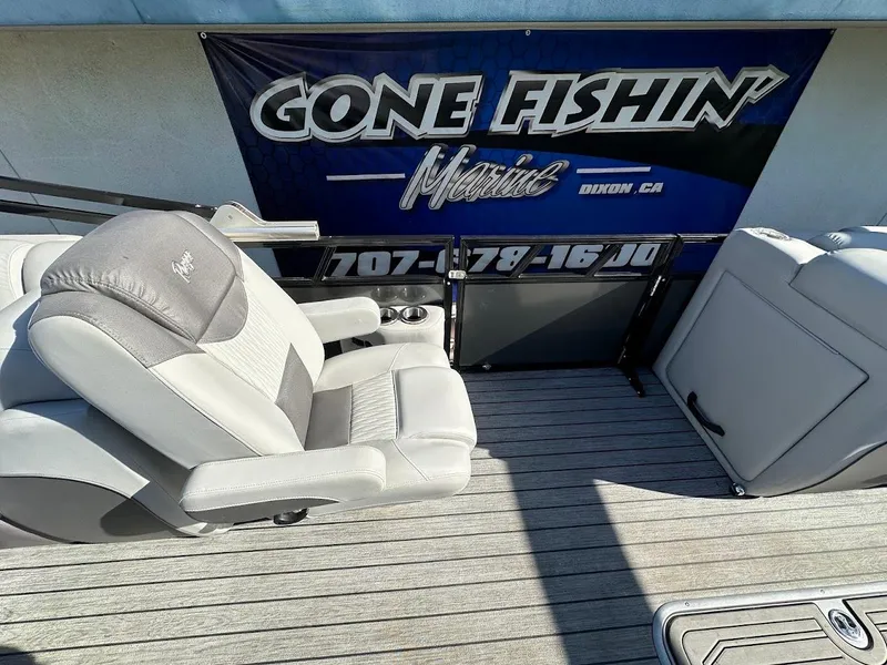 Slide: The Image of 2020 Ranger 2300LS boat interior with seating, "Gone Fishin' Marine" banner in background. - 34