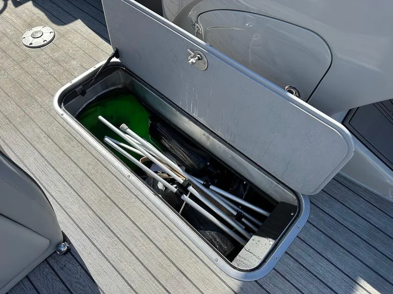 Slide: The Image of Open storage compartment on 2020 Ranger 2300LS boat with equipment inside. - 41