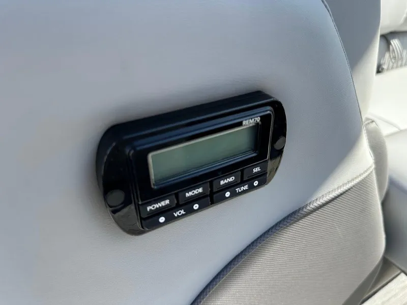 Slide: The Image of Boat stereo control panel on 2020 Ranger 2300LS, featuring power, mode, and volume buttons. - 43