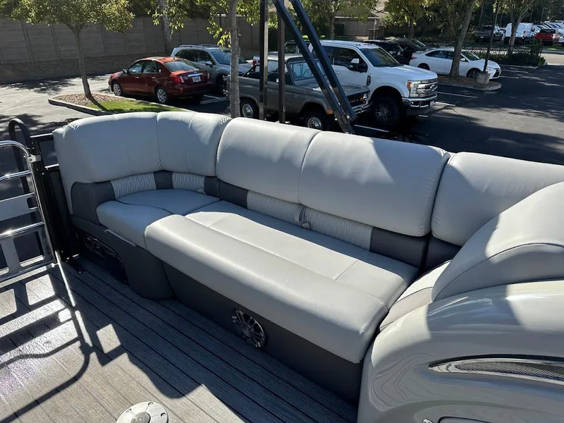 Slide: The Image of 2020 Ranger 2300LS boat with spacious gray seating in a parking lot. - 44