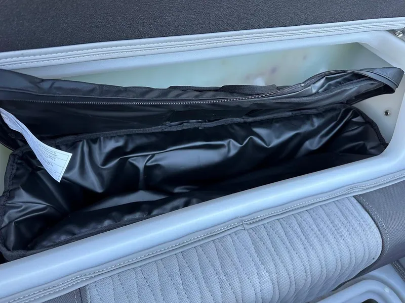 Slide: The Image of Interior storage compartment of 2020 Ranger 2300LS boat with black lining. - 48
