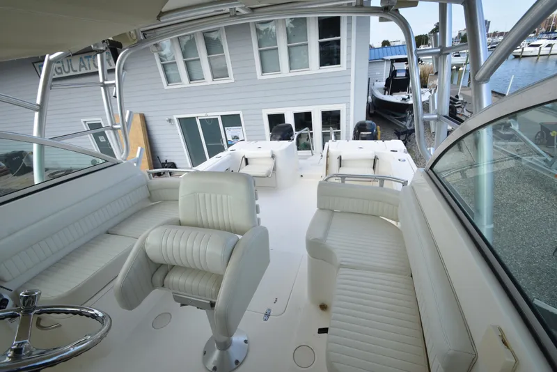 Slide: The Image of 2008 World Cat 32 EC boat interior with white seating and steering wheel. - 14