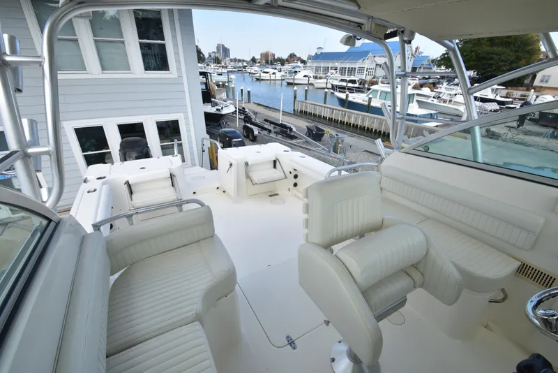Slide: The Image of 2008 World Cat 32 EC boat interior with white seating, docked at marina. - 15