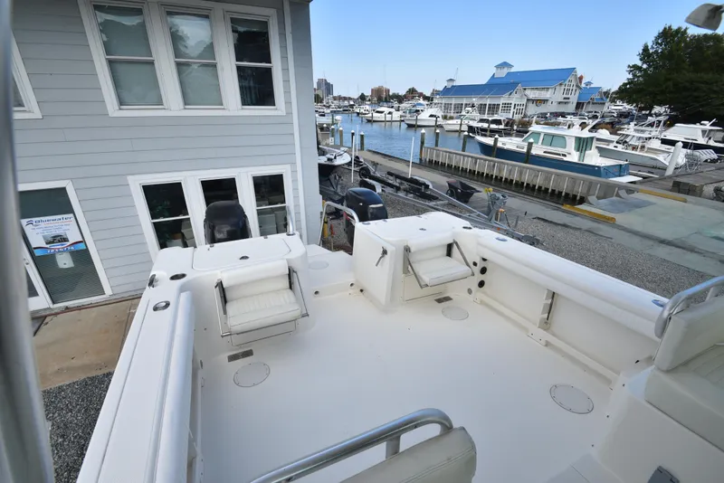 Slide: The Image of 2008 World Cat 32 EC boat docked at marina, spacious deck, waterfront view. - 17