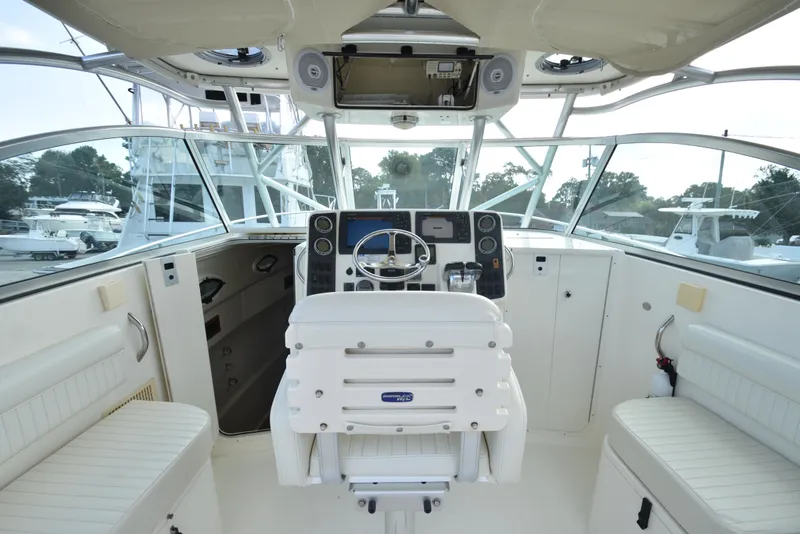 Slide: The Image of 2008 World Cat 32 EC boat cockpit with steering wheel and navigation controls. - 19