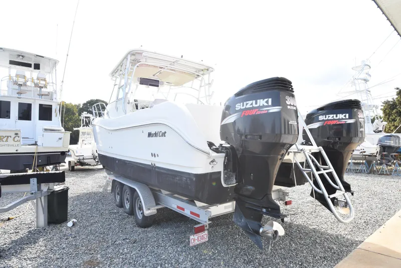 Slide: The Image of 2008 World Cat 32 EC boat with Suzuki outboard motors on a trailer. - 2