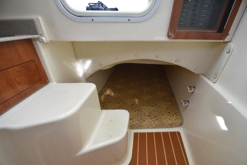 Slide: The Image of 2008 World Cat 32 EC cabin interior with steps and cushioned sleeping area. - 22
