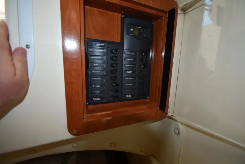 Slide: The Image of Electrical panel inside 2008 World Cat 32 EC boat, featuring various labeled switches. - 24