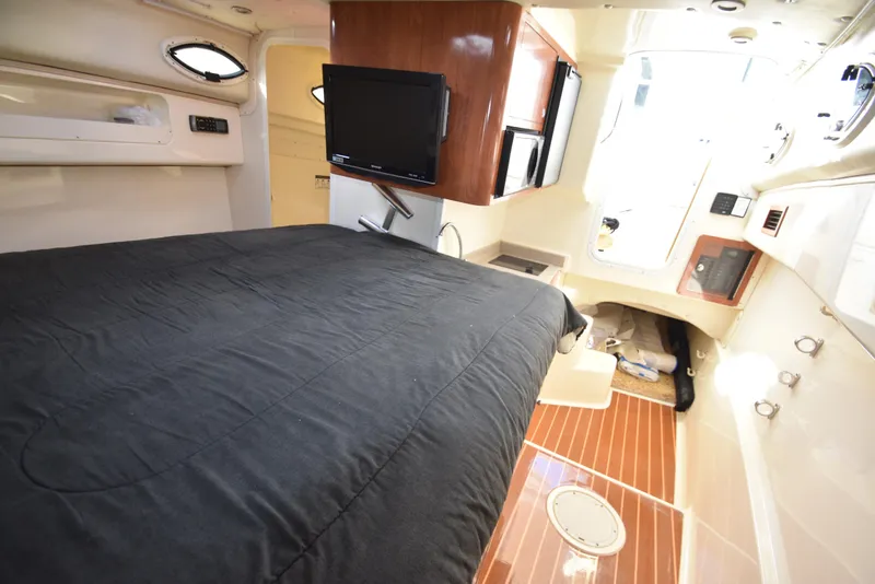 Slide: The Image of Interior of 2008 World Cat 32 EC boat with bed, TV, and wooden flooring. - 29