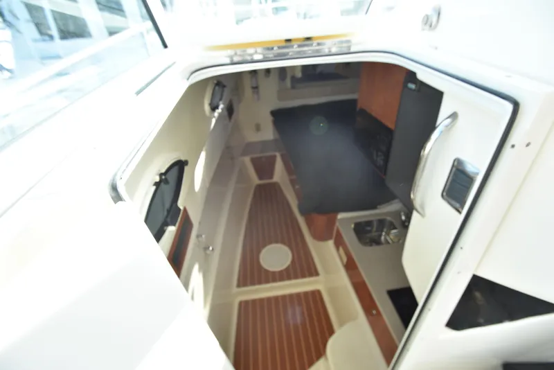 Slide: The Image of Interior cabin of 2008 World Cat 32 EC boat with wood flooring and kitchenette. - 30