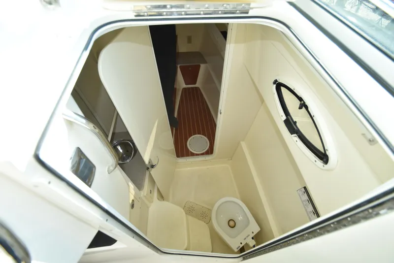 Slide: The Image of Interior of 2008 World Cat 32 EC boat, featuring compact bathroom with toilet and sink. - 31