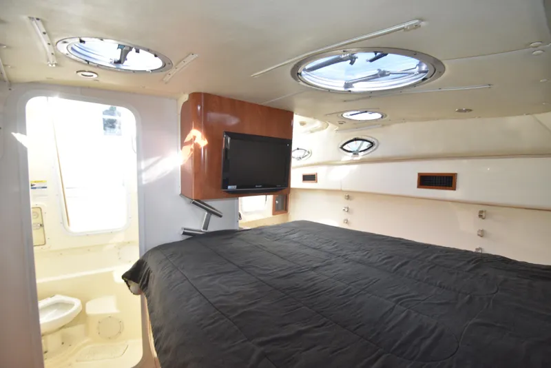Slide: The Image of 2008 World Cat 32 EC cabin interior with bed, TV, and portholes. - 33