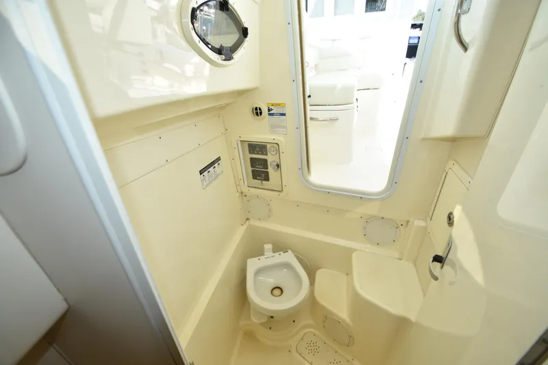 Slide: The Image of 2008 World Cat 32 EC boat interior bathroom with compact toilet and porthole. - 34