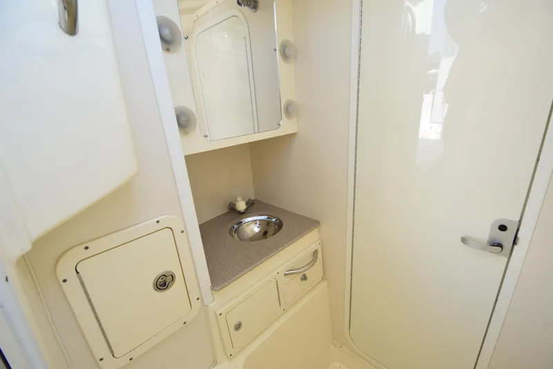 Slide: The Image of 2008 World Cat 32 EC boat interior with sink and storage cabinets. - 37