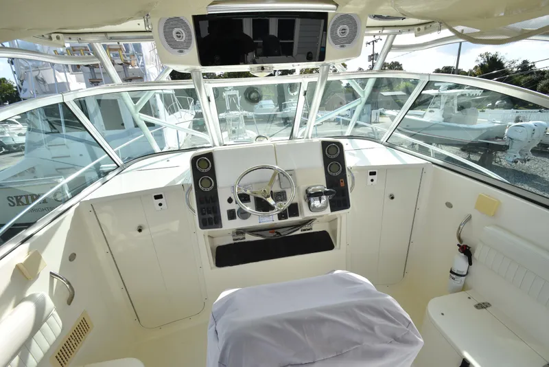 Slide: The Image of 2008 World Cat 32 EC boat cockpit with steering wheel and control panel. - 4