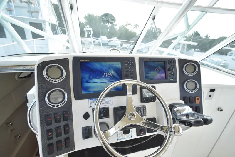 Slide: The Image of 2008 World Cat 32 EC boat helm with dual navigation screens and steering wheel. - 5